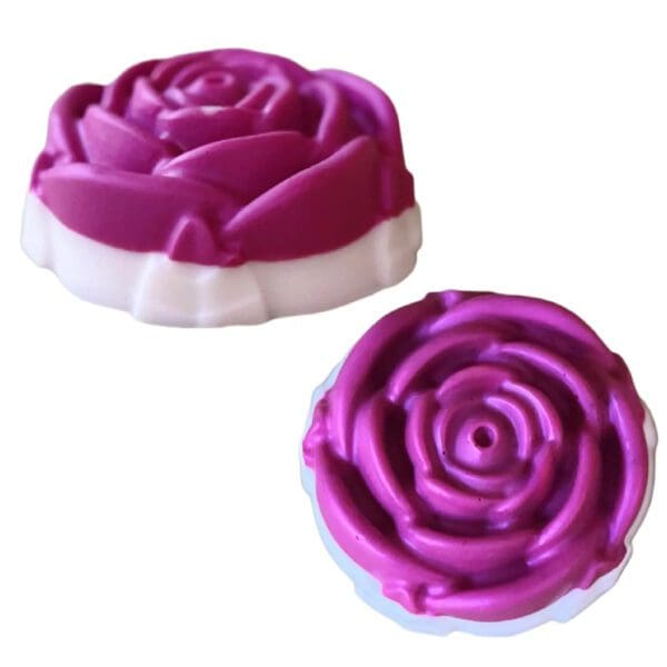 Two purple rose-shaped soap bars.