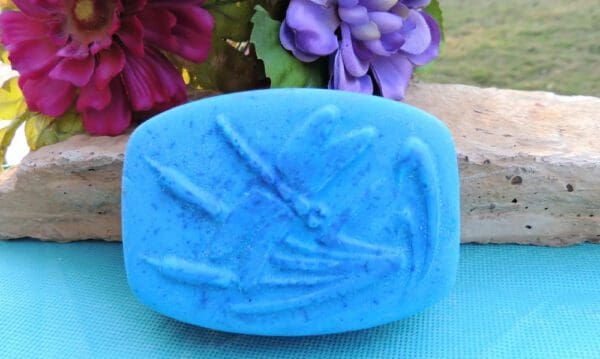 Blue soap bar with dragonfly design.