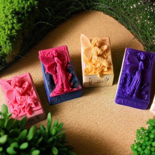 Four zodiac-themed soaps with fairy designs.