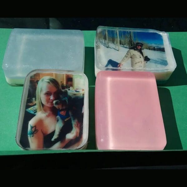 Four clear soaps with printed photos.