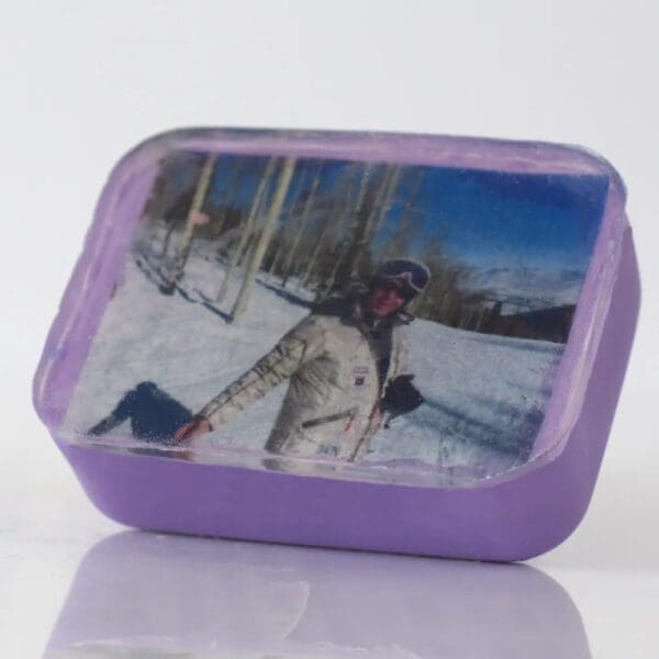 Purple photo block with skier in snow.