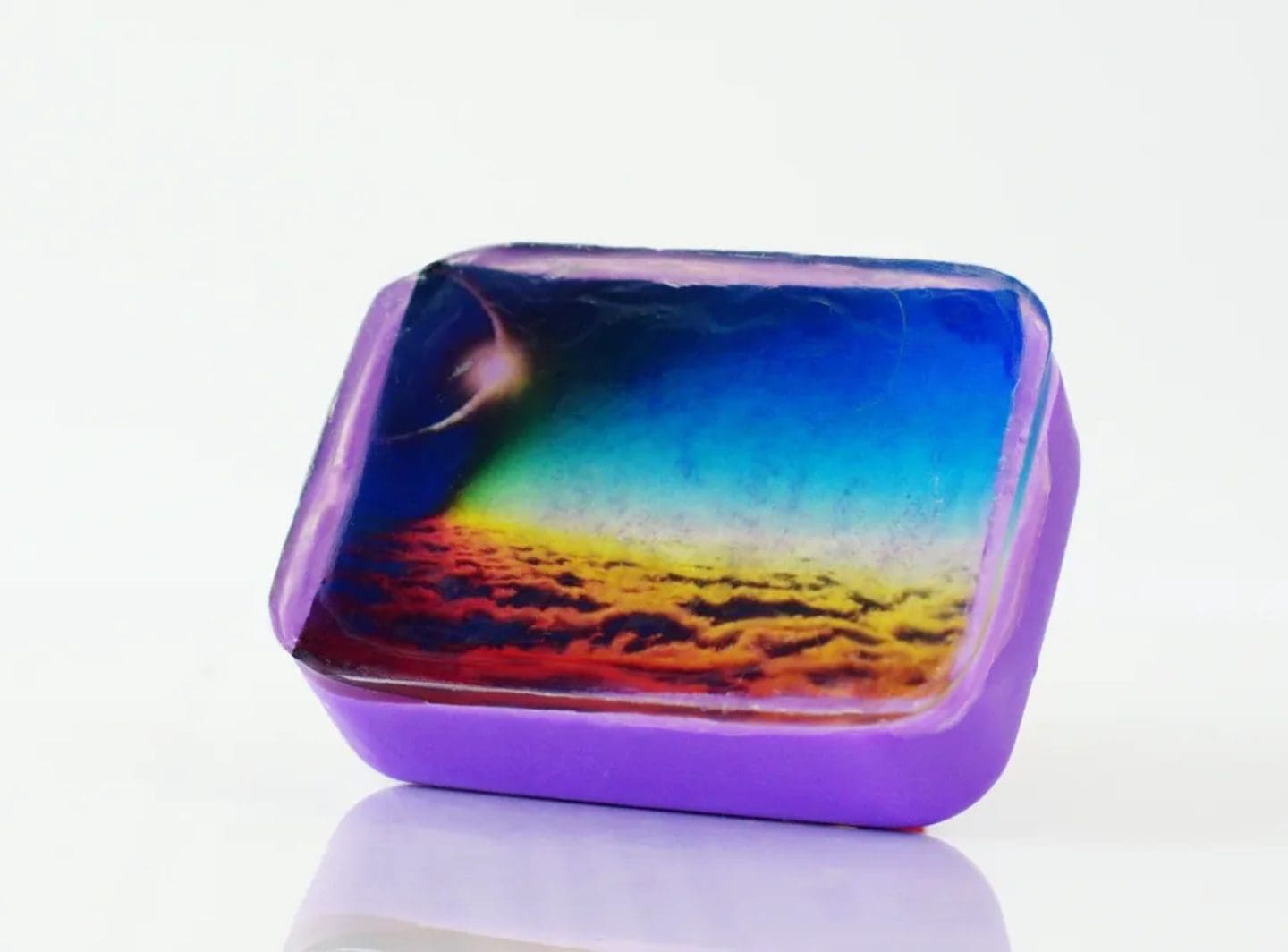 Purple soap with a sunset sky image.