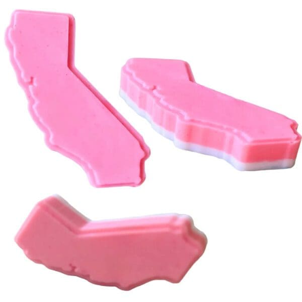 Three pink California state-shaped soaps.