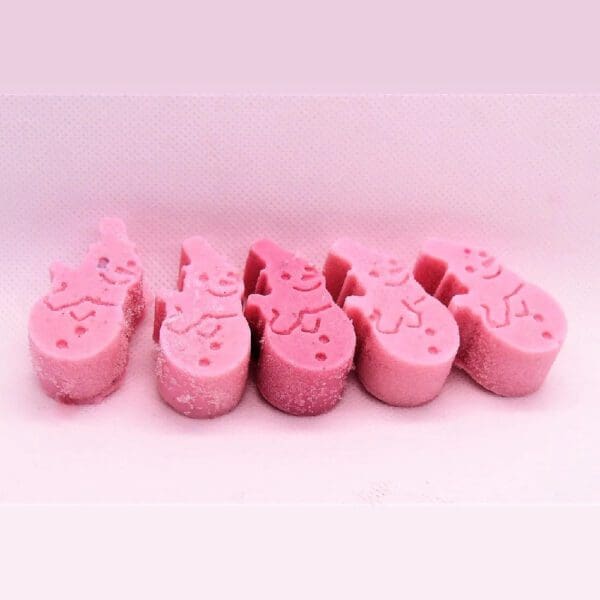 Four pink snowman-shaped candies.