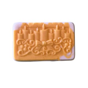 Here's an alt tag for the image: Orange candle soap bar.